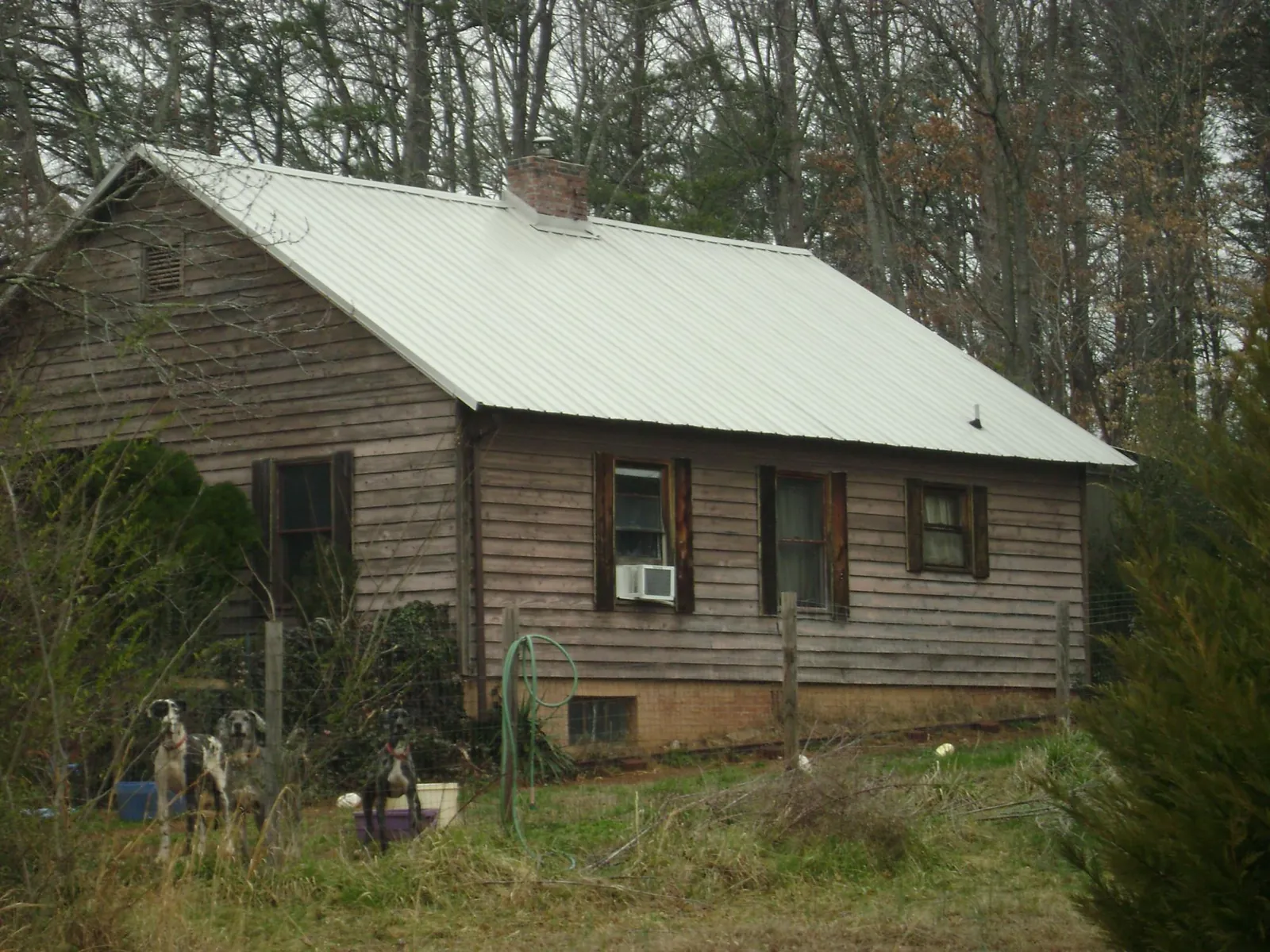 White metal roof on an old wood sided farmhouse, from a Metal Roof Installation job in Manville